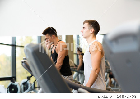 group of men exercising on treadmill in gym group of men exercising on treadmill in gym 14872708
