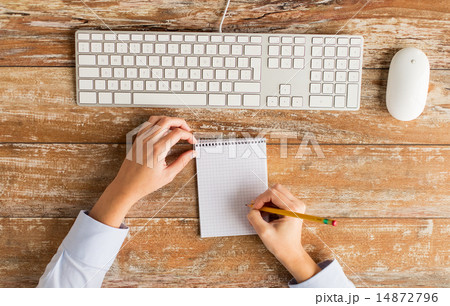 close up of hands with notebook and keyboard 14872796