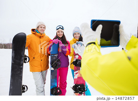 happy friends with snowboards and tablet pc 14872857