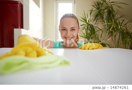 happy woman cleaning table at home kitchen happy woman cleaning table at home kitchen 14874261