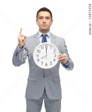 businessman in suit holding clock with 8 o'clock 14874458