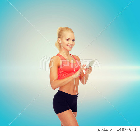 smiling sporty woman with smartphone and earphones smiling sporty woman with smartphone and earphones 14874641