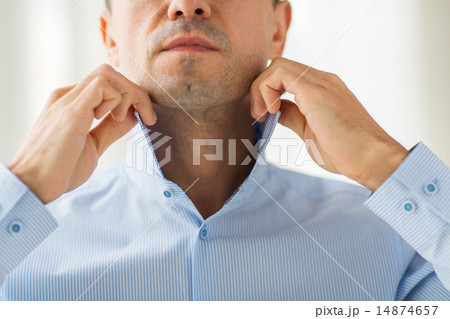 close up of man in shirt dressing close up of man in shirt dressing 14874657