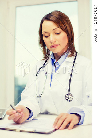 busy doctor with laptop computer and clipboard busy doctor with laptop computer and clipboard 14875017