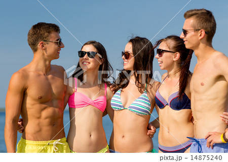 smiling friends in sunglasses on summer beach 14875240