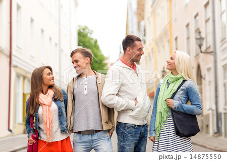 group of smiling friends walking in the city 14875550