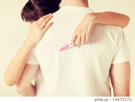 woman with pregnancy test hugging man 14875572