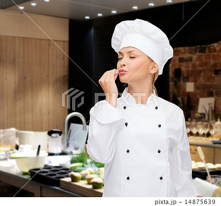 smiling female chef showing delicious sign 14875639
