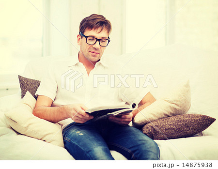 man with magazine at home man with magazine at home 14875938