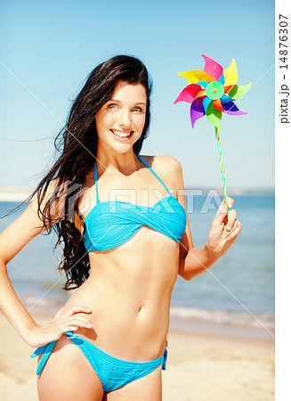 girl with windmill toy on the beach 14876307