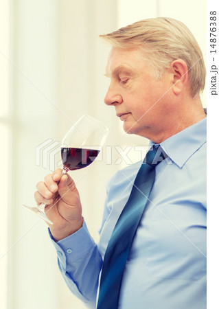 older man smelling red wine older man smelling red wine 14876388