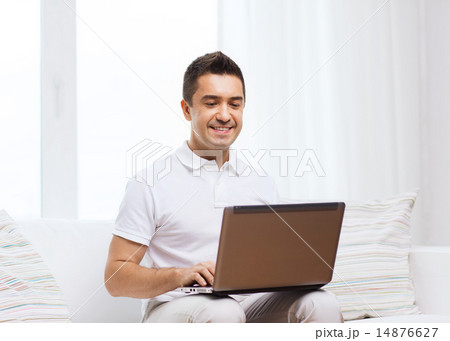happy man working with laptop computer at home happy man working with laptop computer at home 14876627