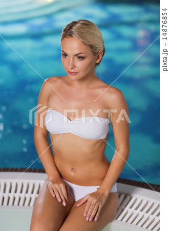 happy woman sitting in jacuzzi at poolside happy woman sitting in jacuzzi at poolside 14876854