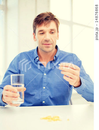man at home showing lot of pills 14876868