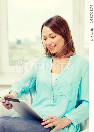 happy woman with tablet pc computer at home 14876874