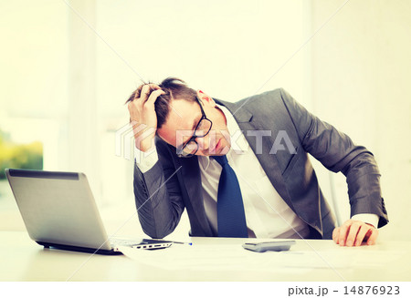 businessman with computer, papers and calculator 14876923