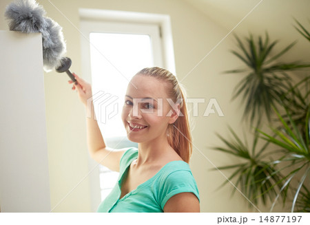 happy woman with duster cleaning at home happy woman with duster cleaning at home 14877197