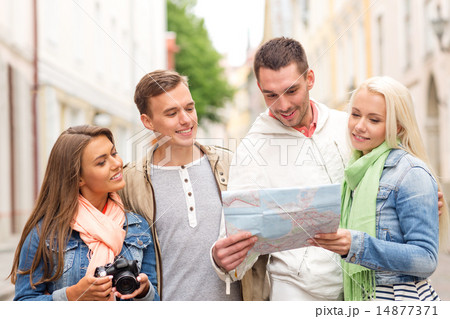 group of smiling friends with map and photocamera group of smiling friends with map and photocamera 14877371