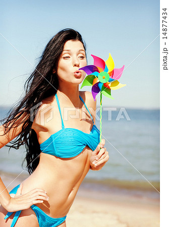girl with windmill toy on the beach girl with windmill toy on the beach 14877434