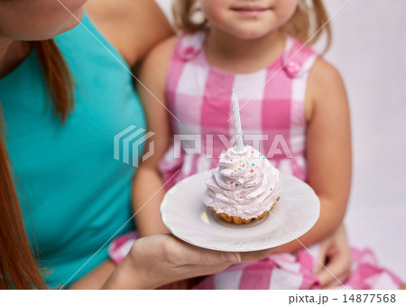 happy mother and little girl holding cupcake 14877568