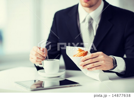man with tablet pc and cup of coffee 14877638