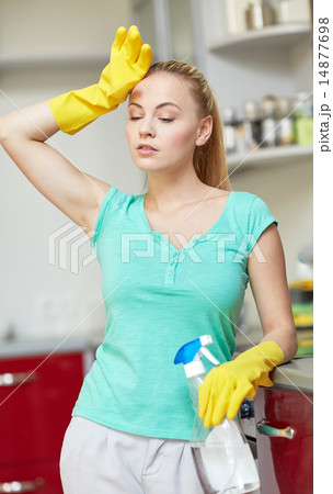 tired woman cleaning home kitchen 14877698