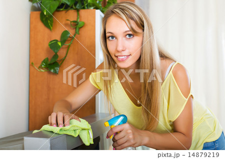 Blonde girl cleaning TV 14879219