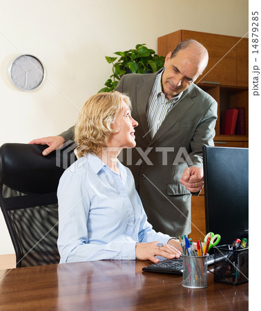 office scene with two mature and happy workers 14879285