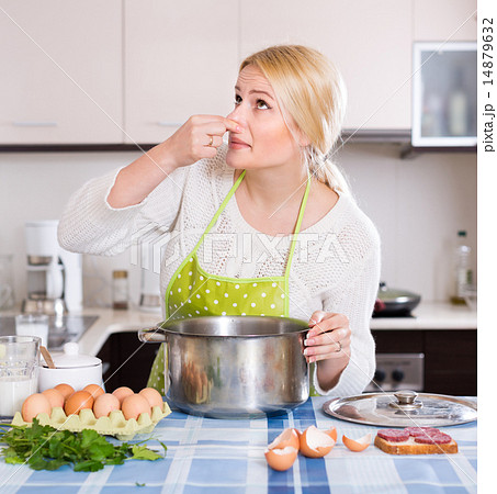 Woman feeling bad smell from pan Woman feeling bad smell from pan 14879632
