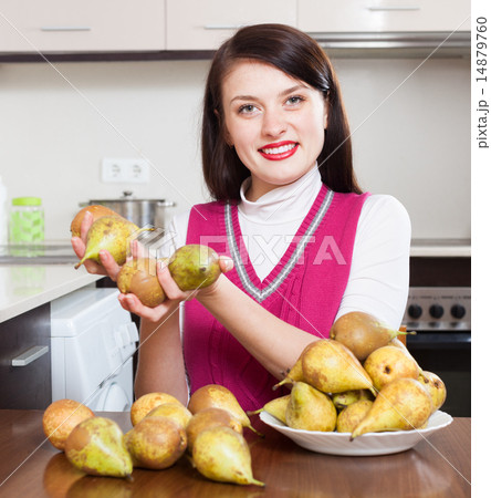 Happy young housewife with pears 14879760