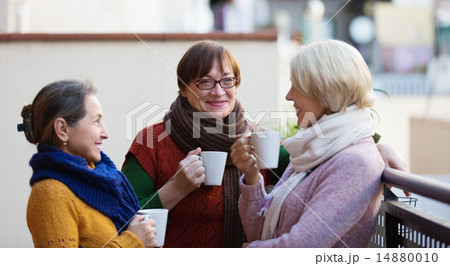 Women having tea on terrace Women having tea on terrace 14880010
