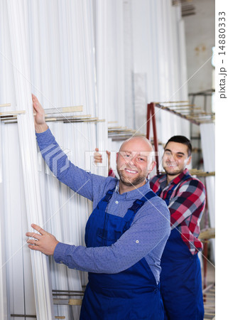 Workmen choosing PVC window profile Workmen choosing PVC window profile 14880333