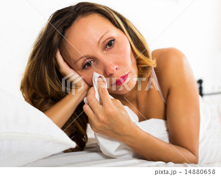 Thoughtful female lies in bedroom 14880658
