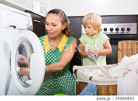 Woman with child near washing machine 14880665