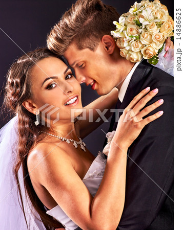 Couple wearing wedding dress and costume. 14886625