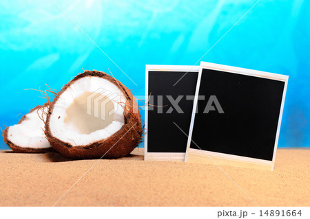 chopped coconut and photoframe on the sand 14891664