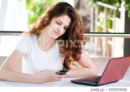A young business woman sitting in a cafe A young business woman sitting in a cafe 14895686