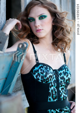 Fashion woman with green make-up at rural location 14896404