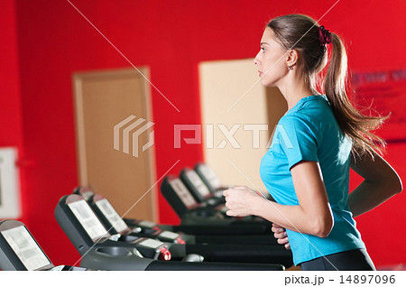 Gym exercising. Run on on a machine. 14897096