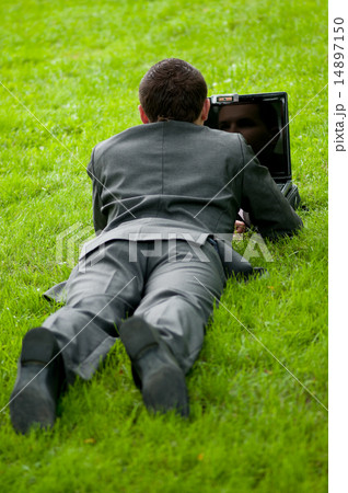 business man work on notebook at park. Student 14897150