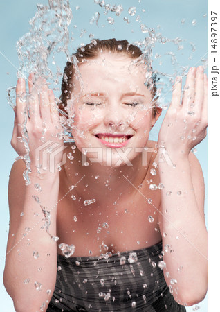 Portrait of beautiful emotional woman washing face 14897397