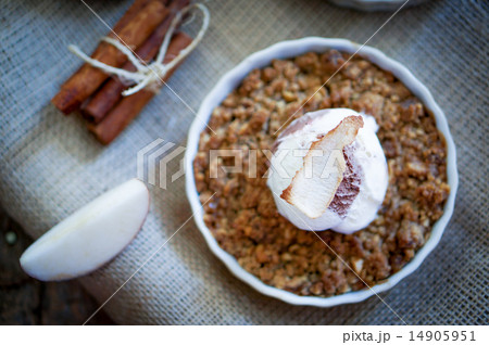 Apple crumble dessert with cinnamon and vanilla ice -cream on wo 14905951