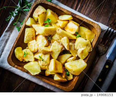 Baked potatoes on wooden background Baked potatoes on wooden background 14906153