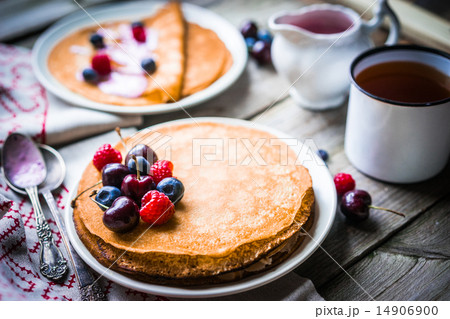Pancakes with berries on wooden background Pancakes with berries on wooden background 14906900