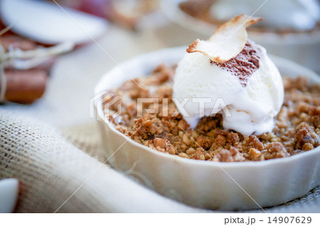 Apple crumble dessert with cinnamon and vanilla ice -cream on wo 14907629