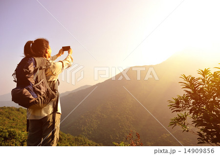 woman hiker taking photo with smart phone woman hiker taking photo with smart phone 14909856