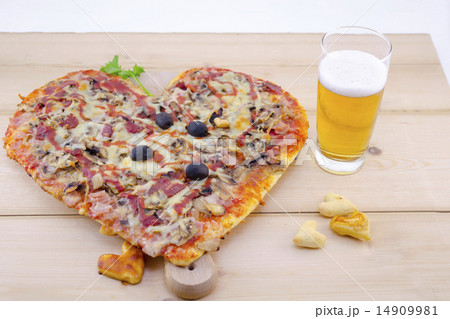 Heart shaped pizza and a glass of beer 14909981
