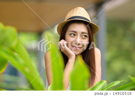 Young Chinese woman putting one hand on her face 14910516