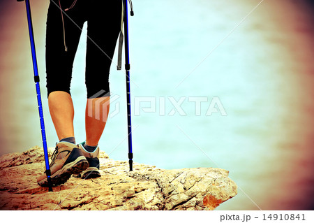 woman hiker hiking stand on seaside rock woman hiker hiking stand on seaside rock 14910841