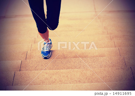 sports woman legs running up on stone stairs 14911695